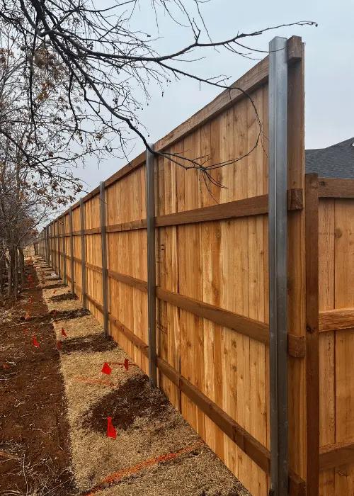 Fence post set in a concrete footing in Oklahoma City