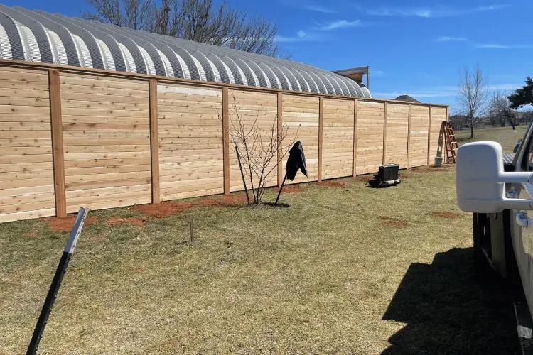Wood fence post set plumb in concrete in the Oklahoma City metro