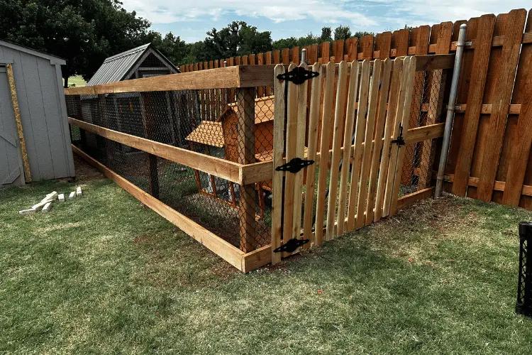 Chain link fence with a wood top rail around a yard in Oklahoma City