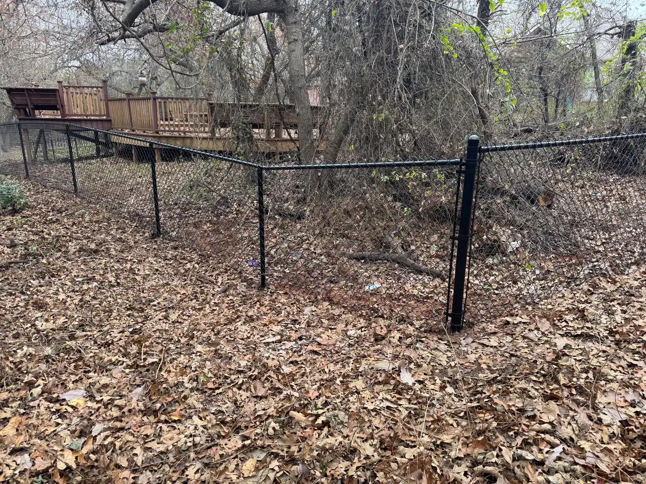 Black vinyl-coated chain link fence installed at an Oklahoma City home