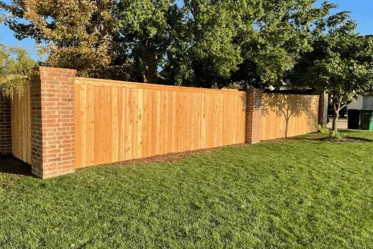 Sturdy brick-and-wood privacy fence built for wind in Oklahoma City