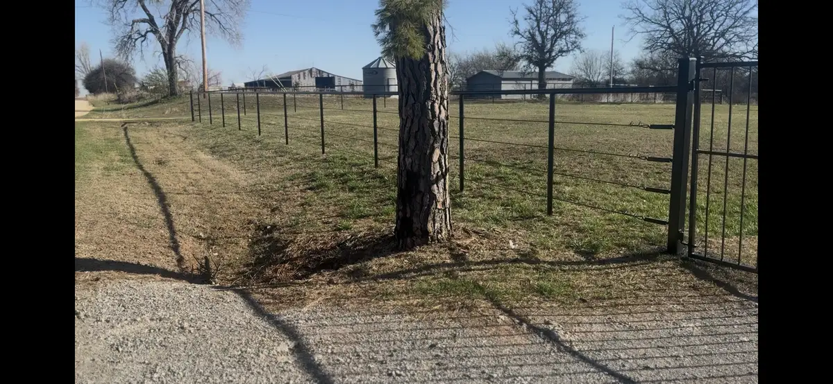 Black chain link fence running along acreage in the Oklahoma City metro