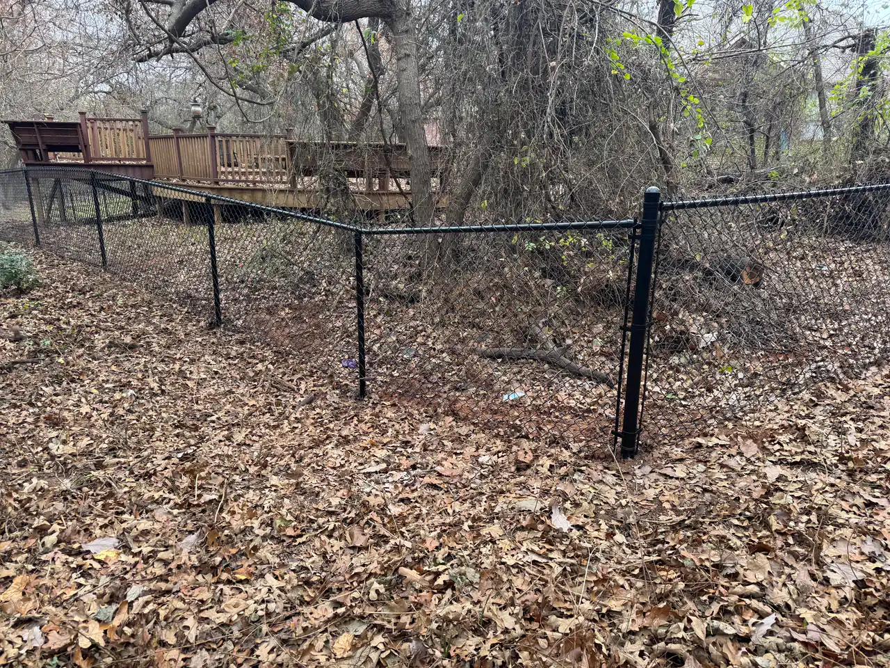 Black vinyl-coated chain link fence installed at an Oklahoma City home