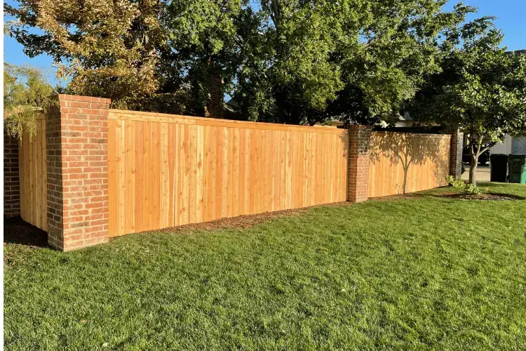 Solid brick-post cedar privacy fence built to block wind and noise in Oklahoma City