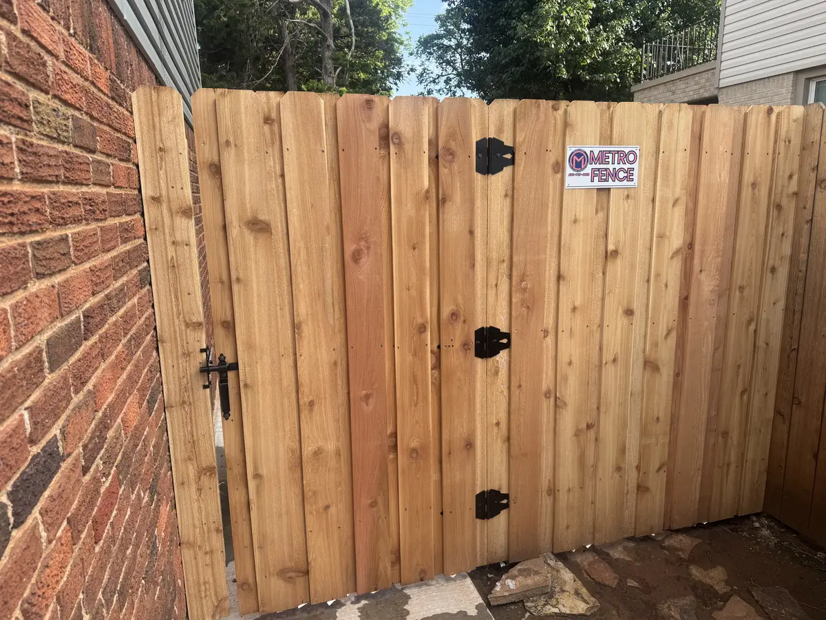 Cedar privacy gate set between brick columns, installed in the Oklahoma City metro