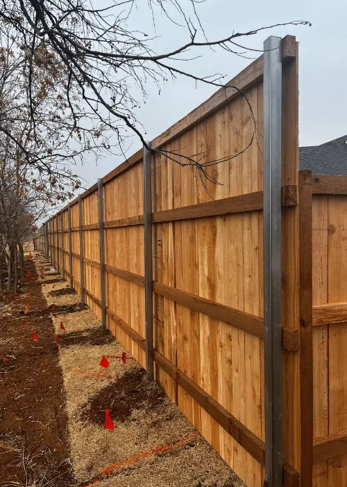 Fence post set in a concrete footing in Oklahoma City