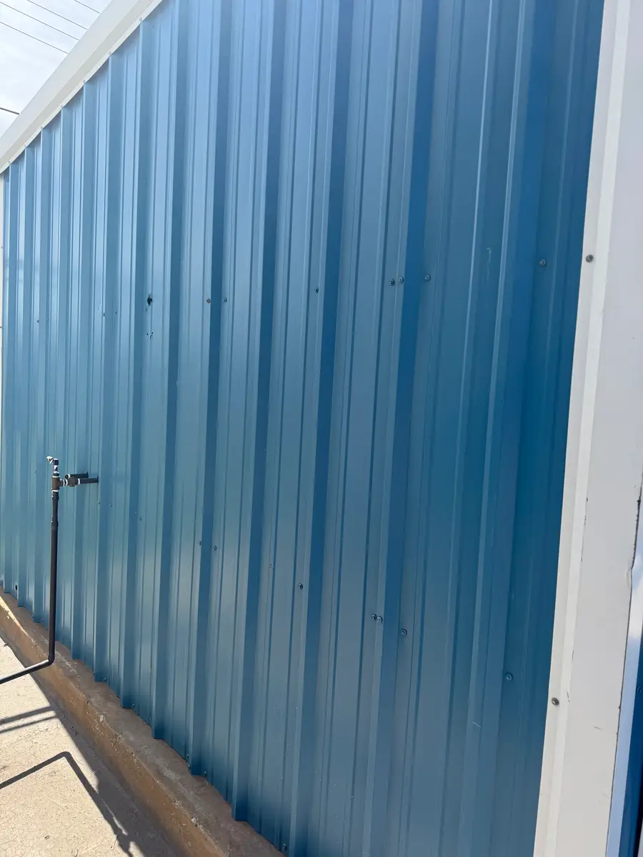 Blue R-panel corrugated steel fence installed in the Oklahoma City metro