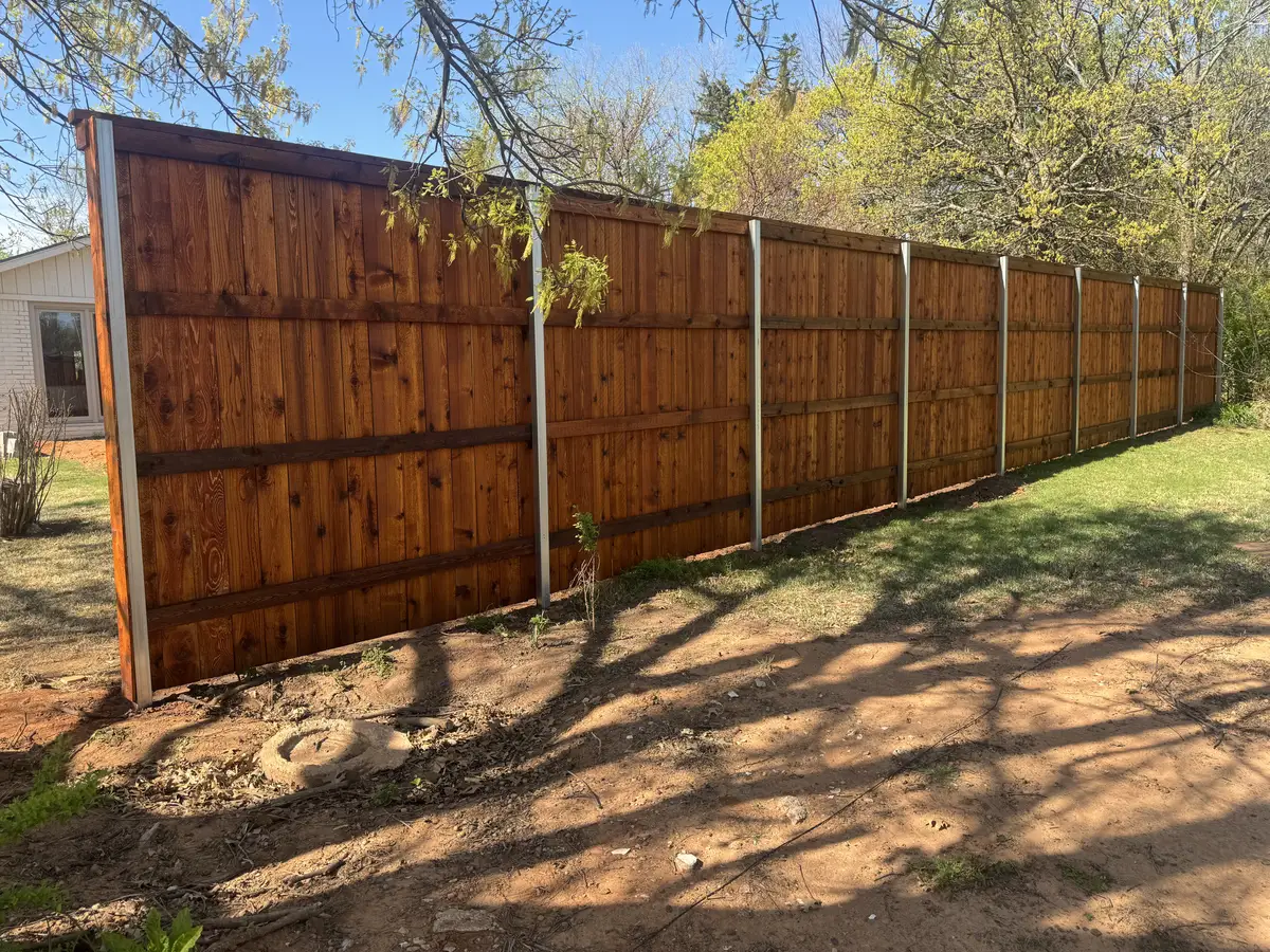 Stained cedar privacy fence on galvanized steel line posts in Oklahoma City