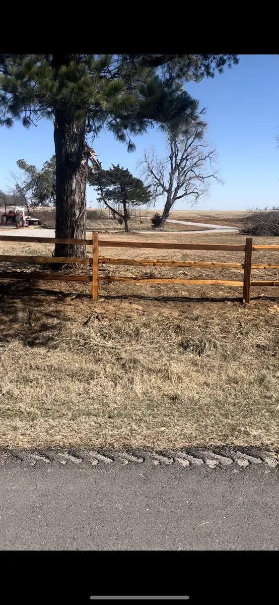Wood post and rail farm fence on an Oklahoma property