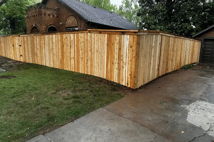 Wood privacy fence being prepared for winter in Oklahoma City
