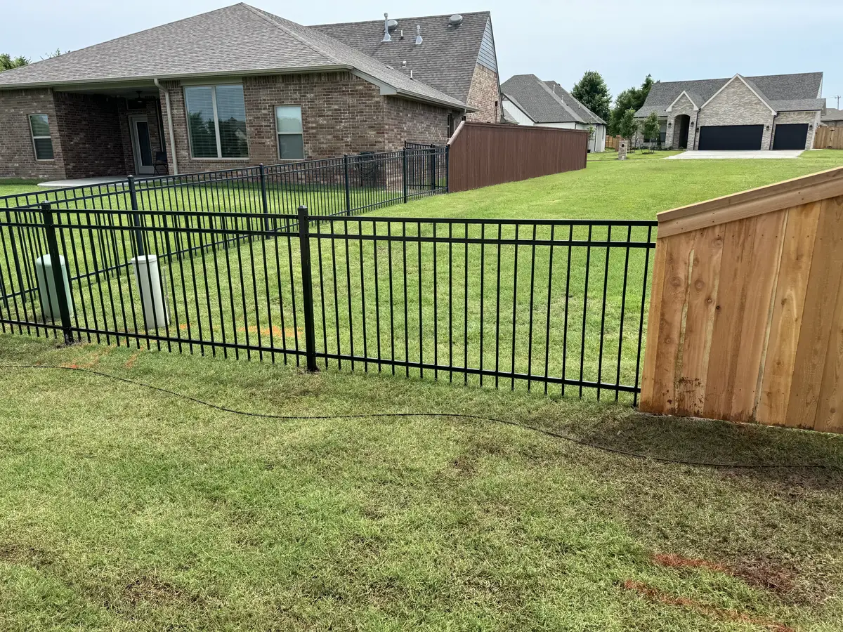 Black wrought iron fence and gate around an Oklahoma City back yard