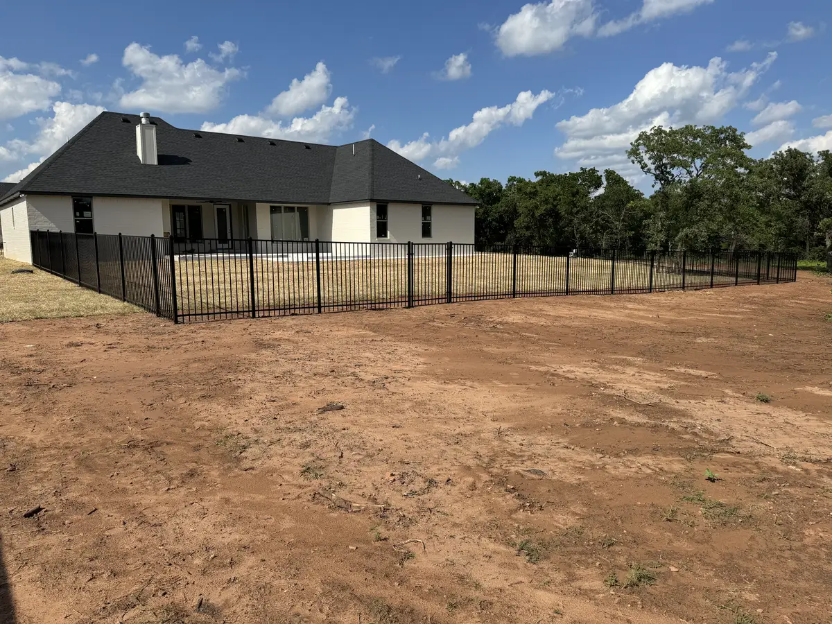 Black wrought iron fence around a newly built Oklahoma City home