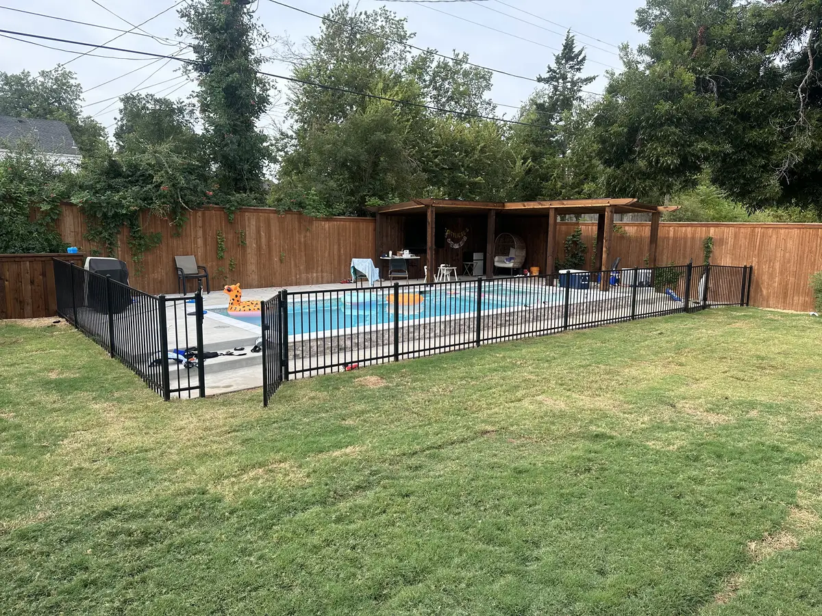 Black iron pool fence enclosing a swimming pool at an Oklahoma City home
